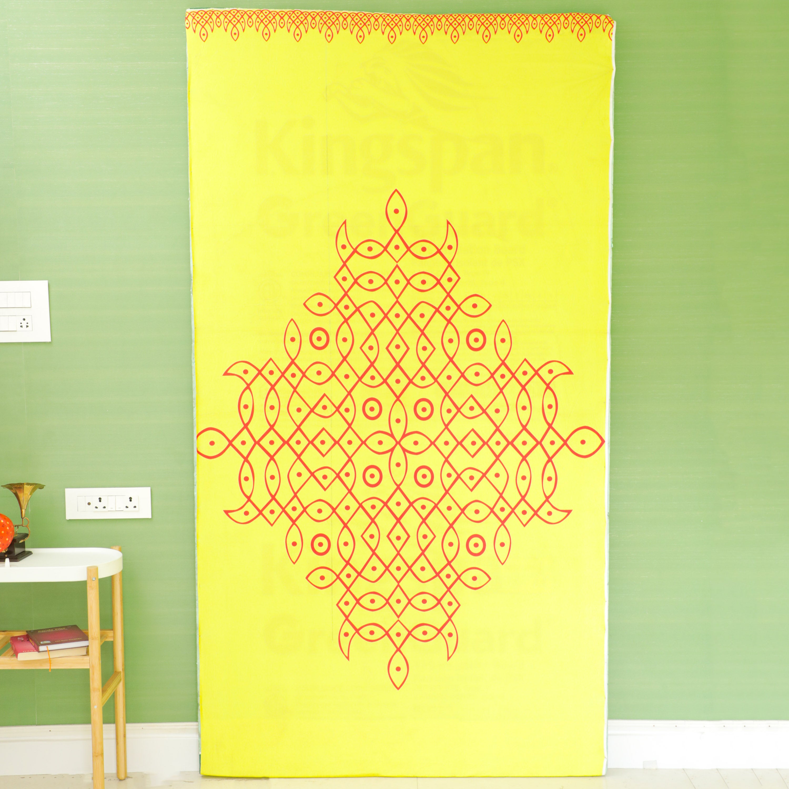Printed rangoli design on yellow color cloth