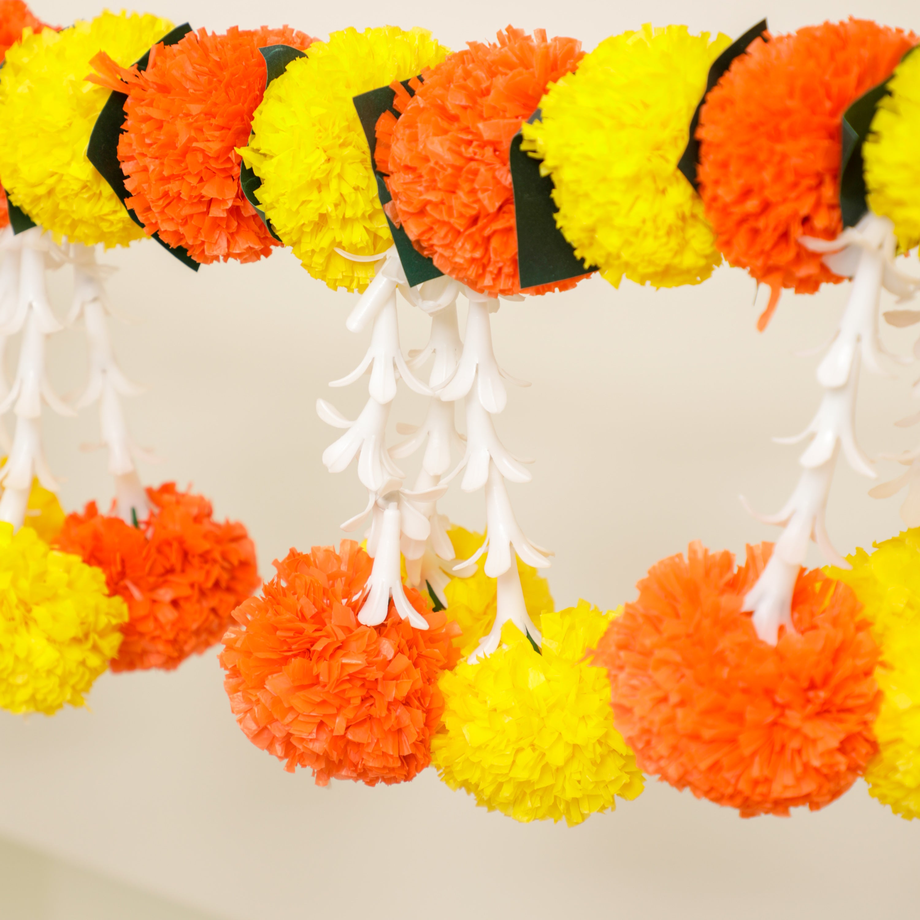 Made of high-quality artificial flowers, this toran exudes a vibrant and realistic feel