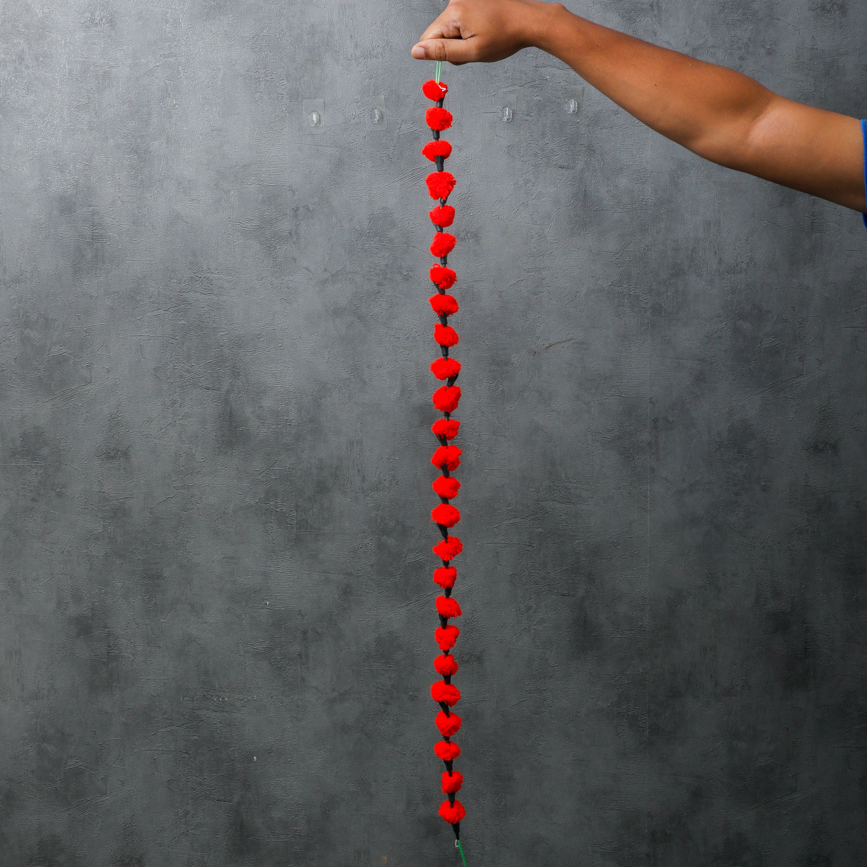 These handmade woolen garlands measure 3.5 feet in length and come with a convenient knob for easy hanging.