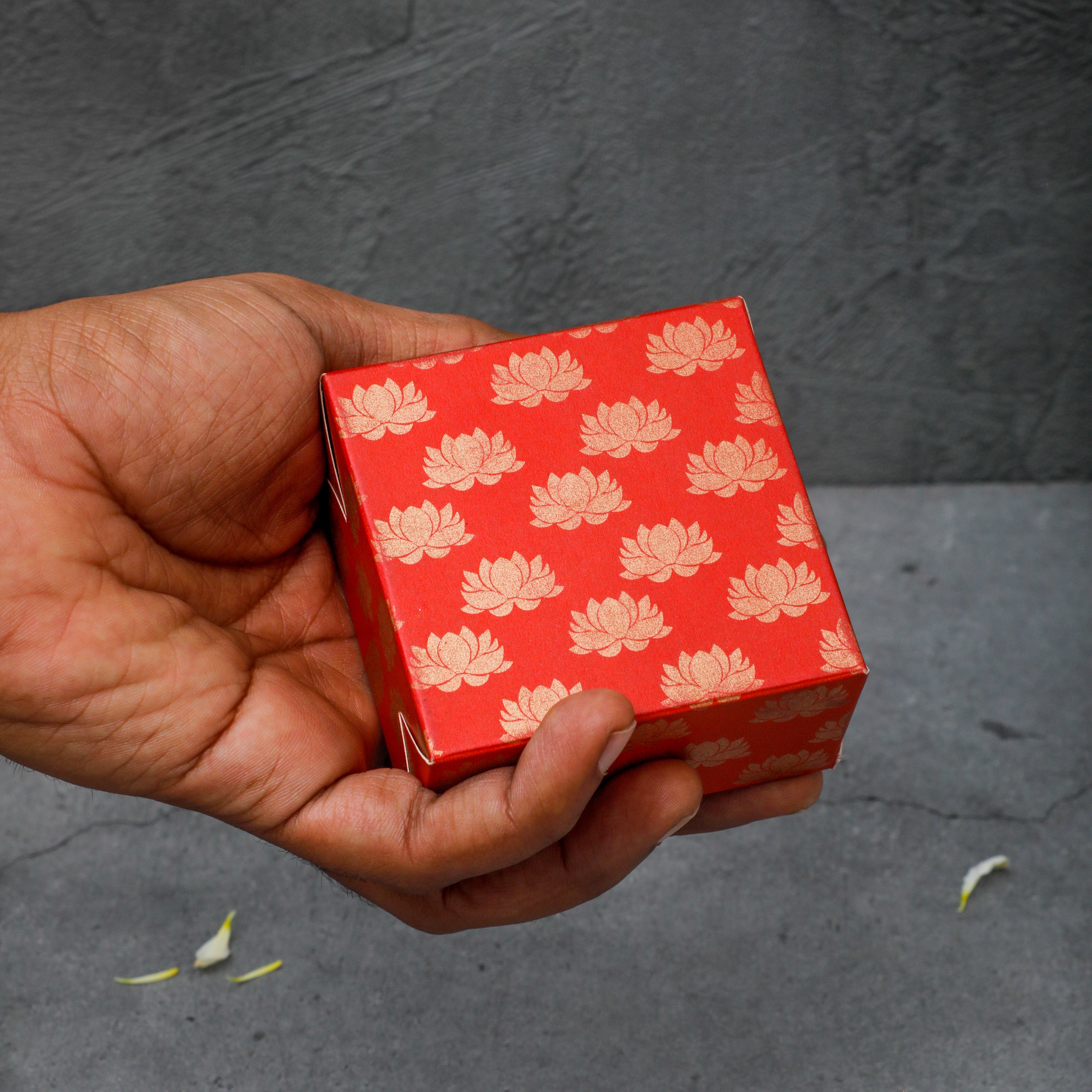 Red in color printed with gold foil Lotus design