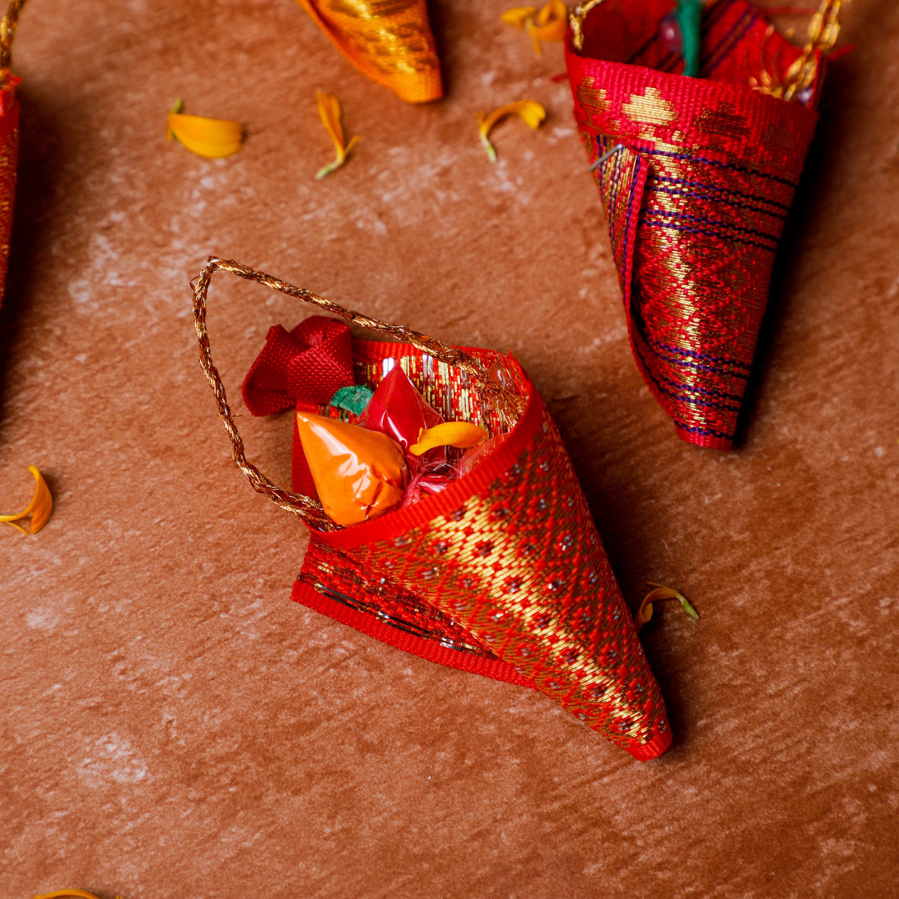 A beautiful cone shaped haldi kumkum with strings attached to it.