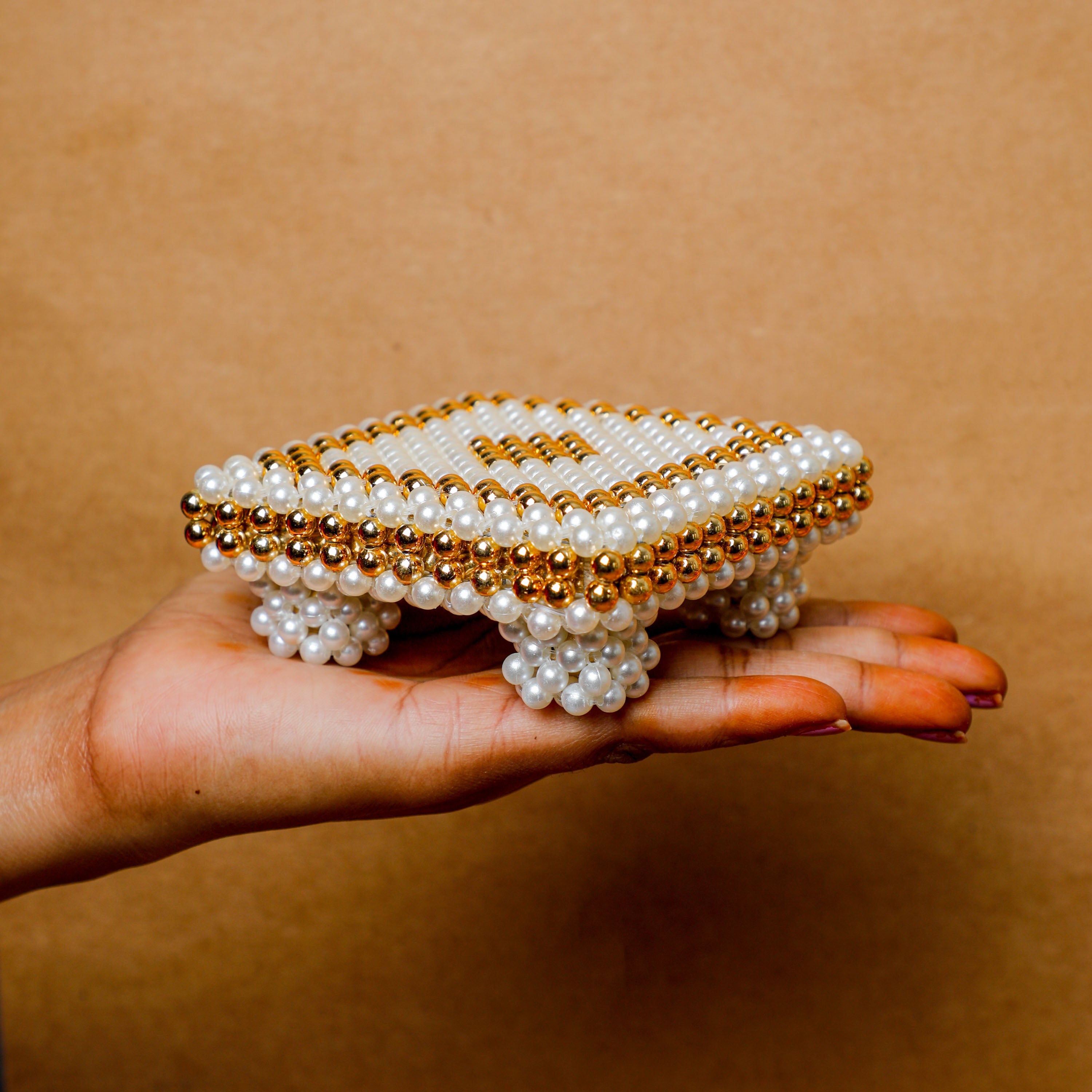 designed with great care, featuring a charming pattern of white and kesari pearls