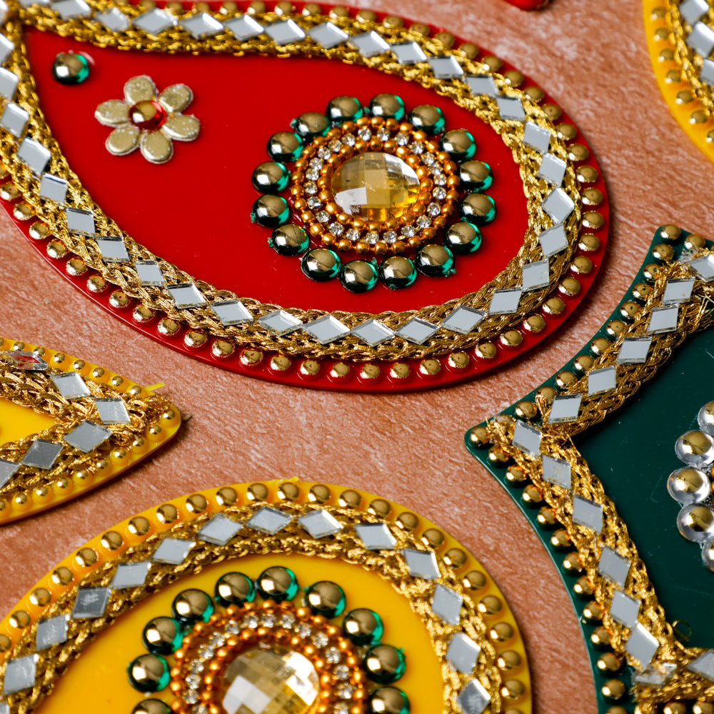 Experience the opulence of our rangoli studded with stones, embellished with intricate gota patti, and adorned with pearls.