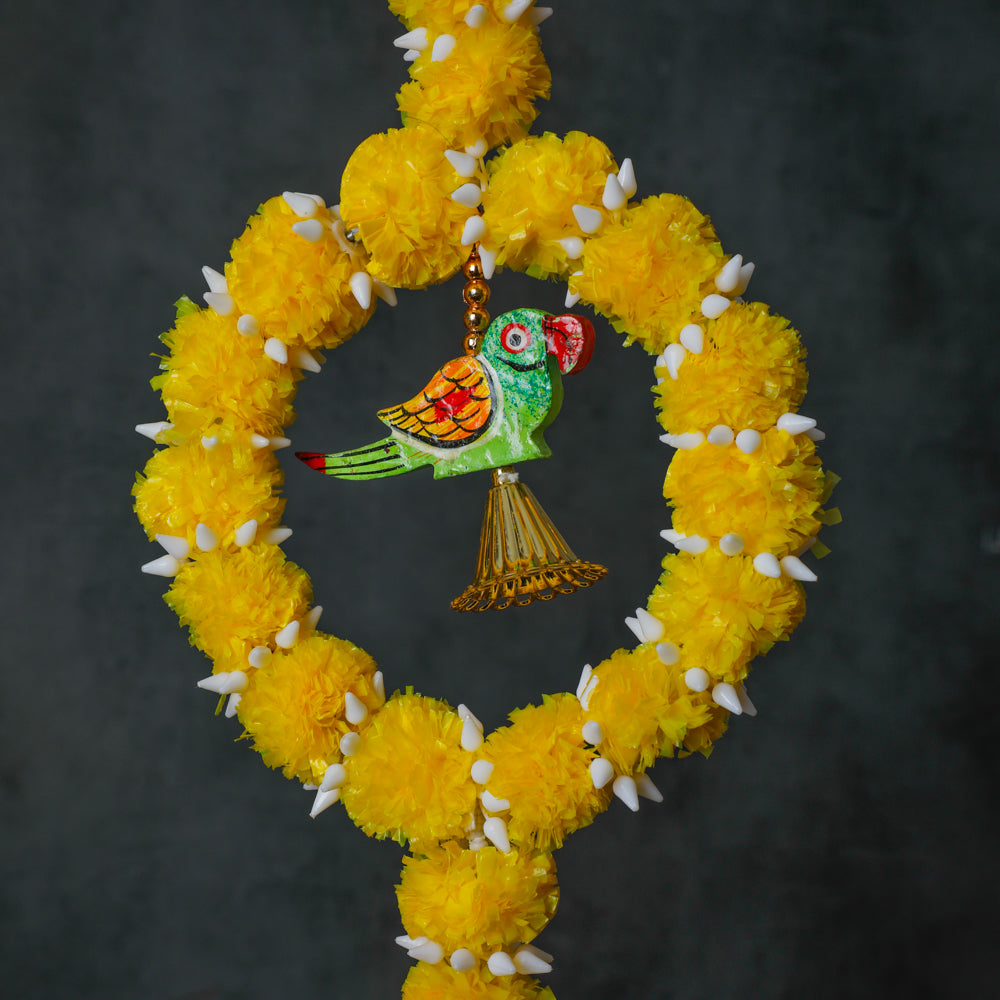 This garland is crafted from artificial flowers and designed with a colorful parrot pattern with hanging bells.