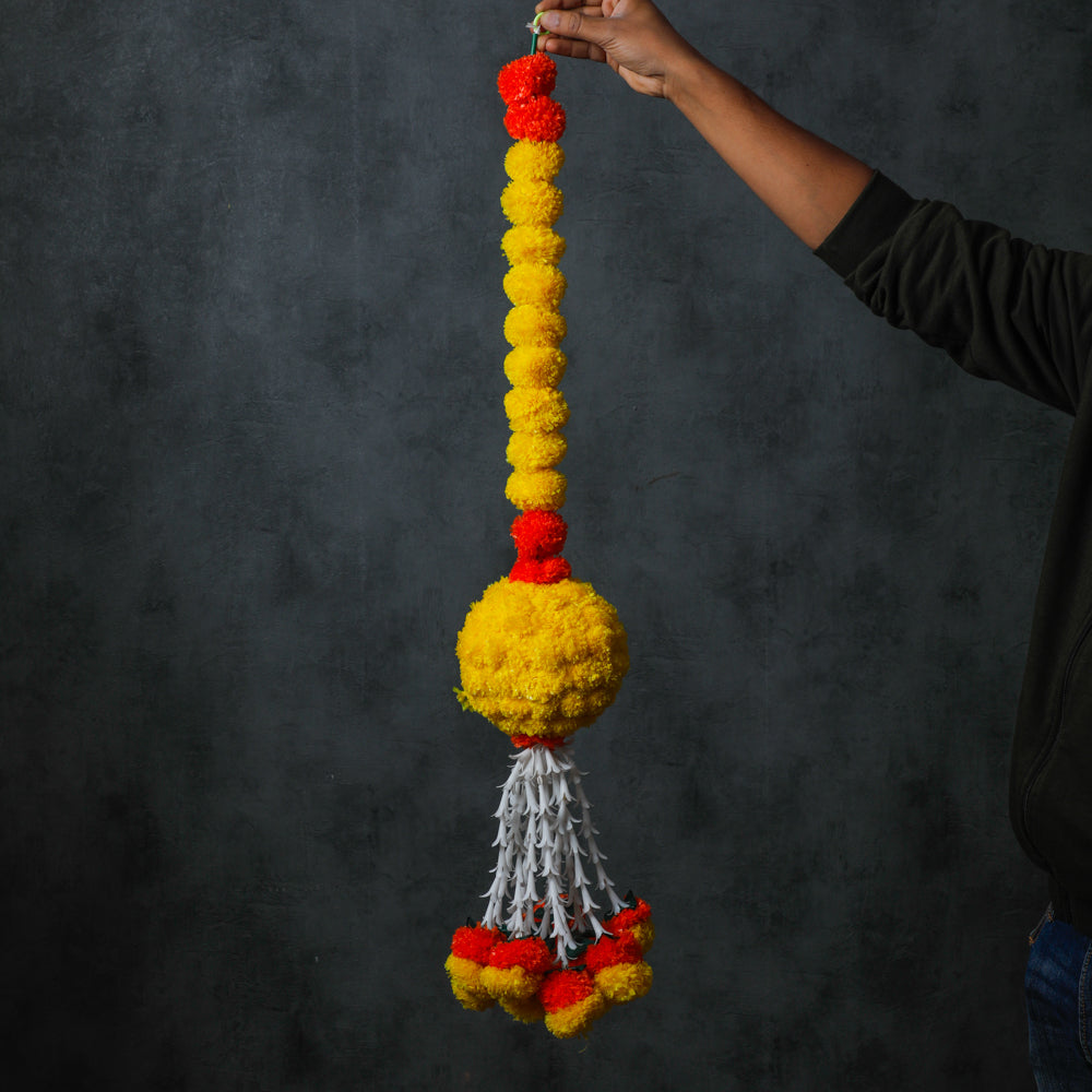 Crafted with artificial flowers in orange and yellow, its enduring charm and easy maintenance