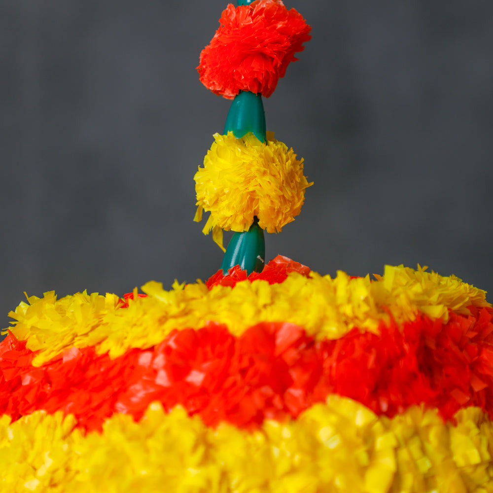 aAdorned with vibrant artificial marigold flowers