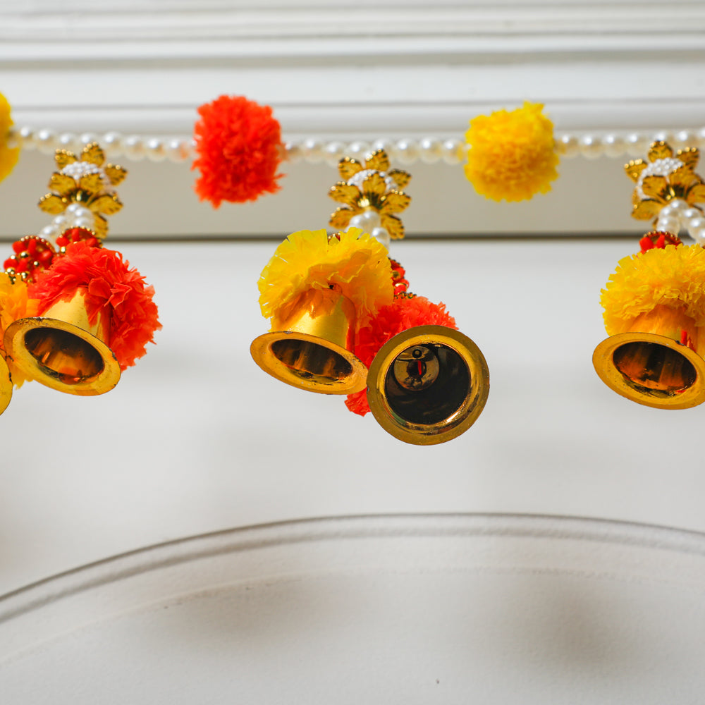 Toran adorned with gold-coated bells.