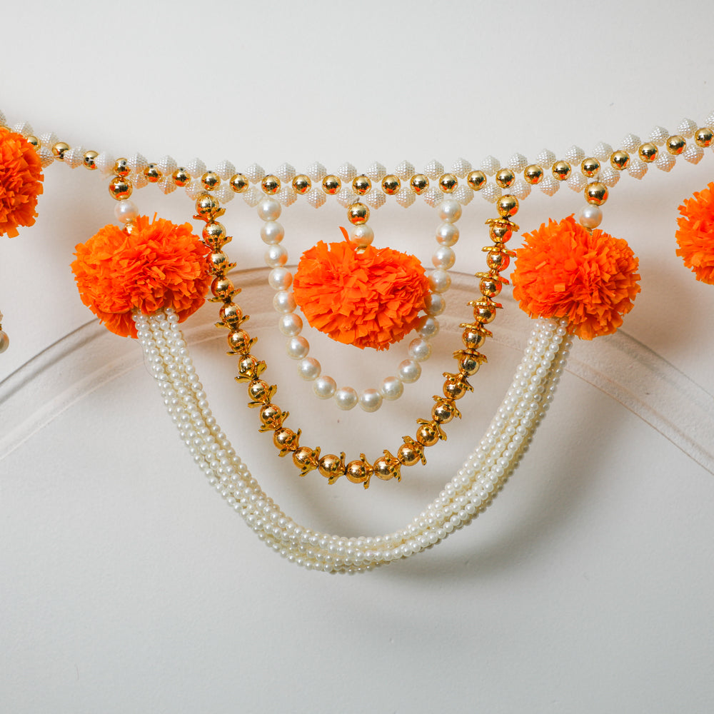 The decorative door hangings with decorative pearl-studded hanging rings, also dazzle with kundan stones