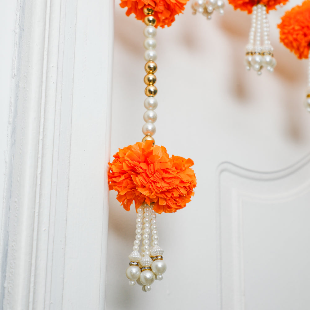 Our toran boasts intricate craftsmanship, featuring artificial beads with marigold flowers
