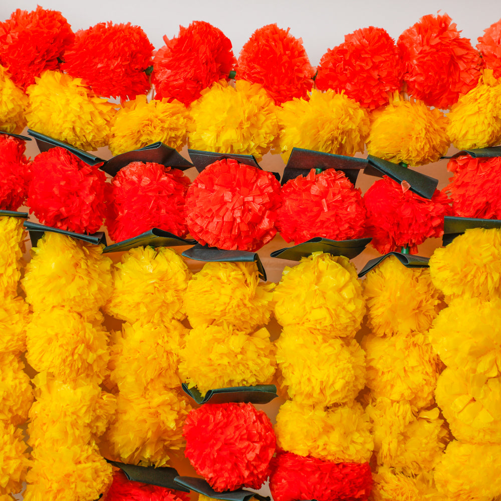 each piece is carefully crafted with artificial marigold flowers and adorned with green mango leaves.