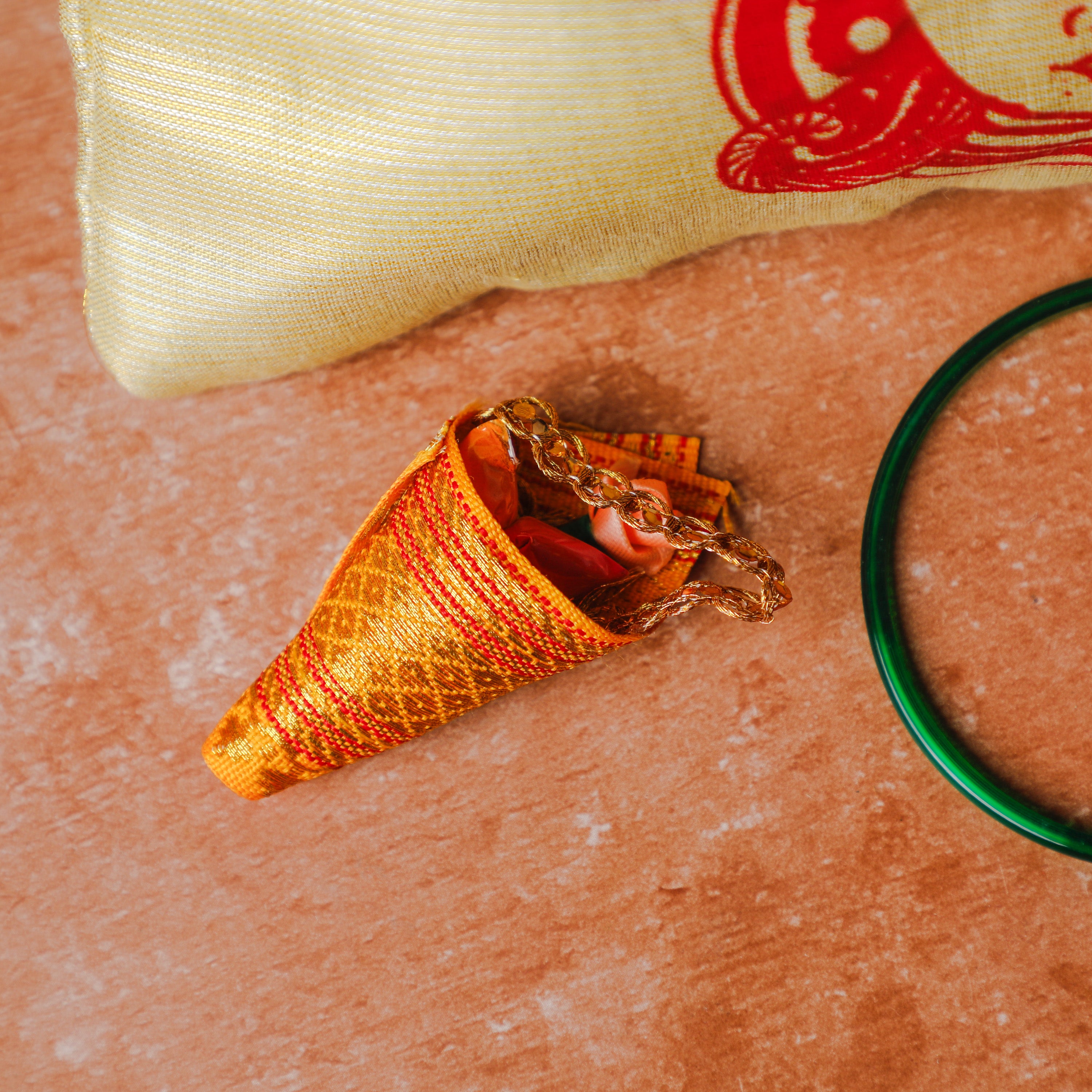 Haldi kumkum wrapped in a zari cloth pouch