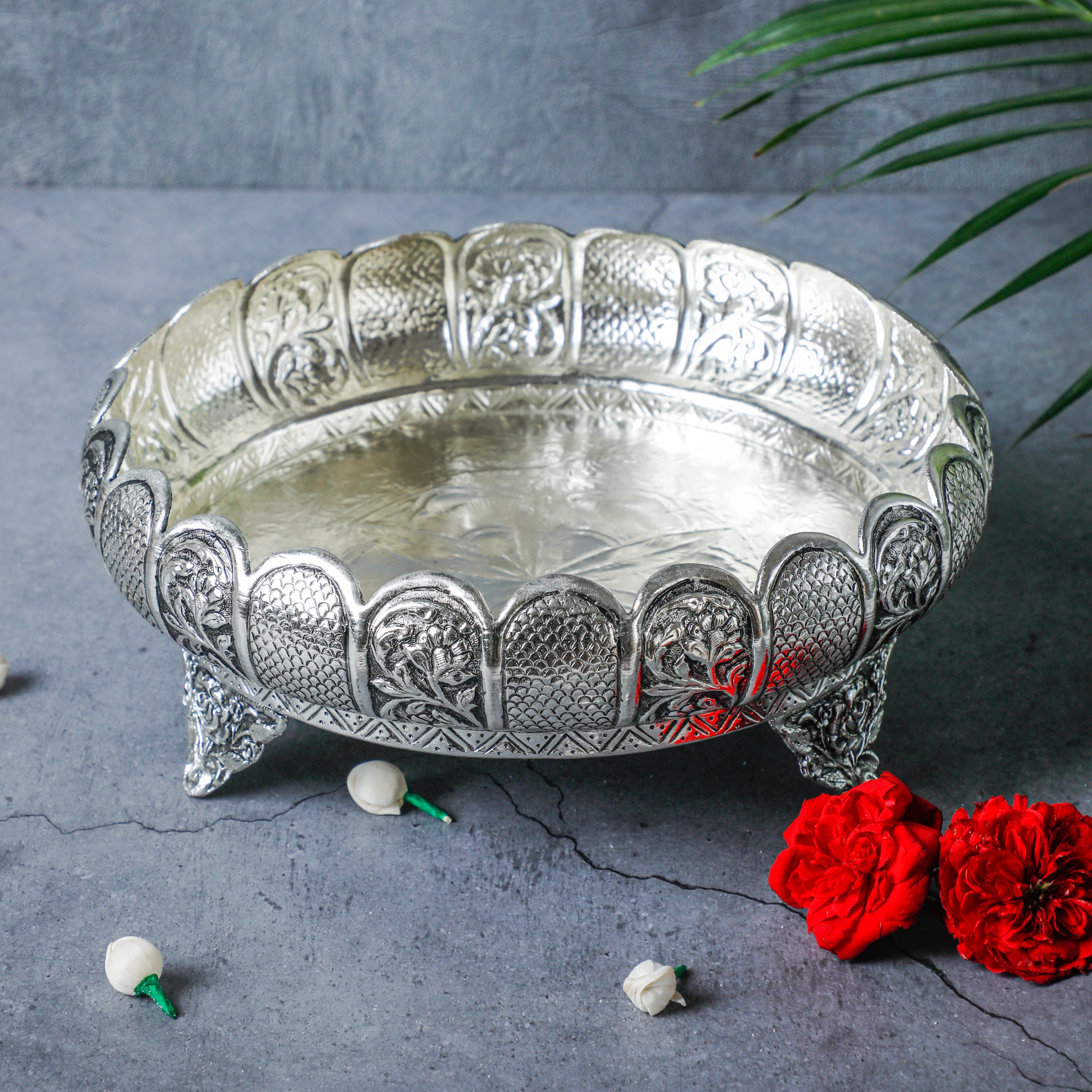 Elevate your pooja space with this gorgeous white silver-plated urli.