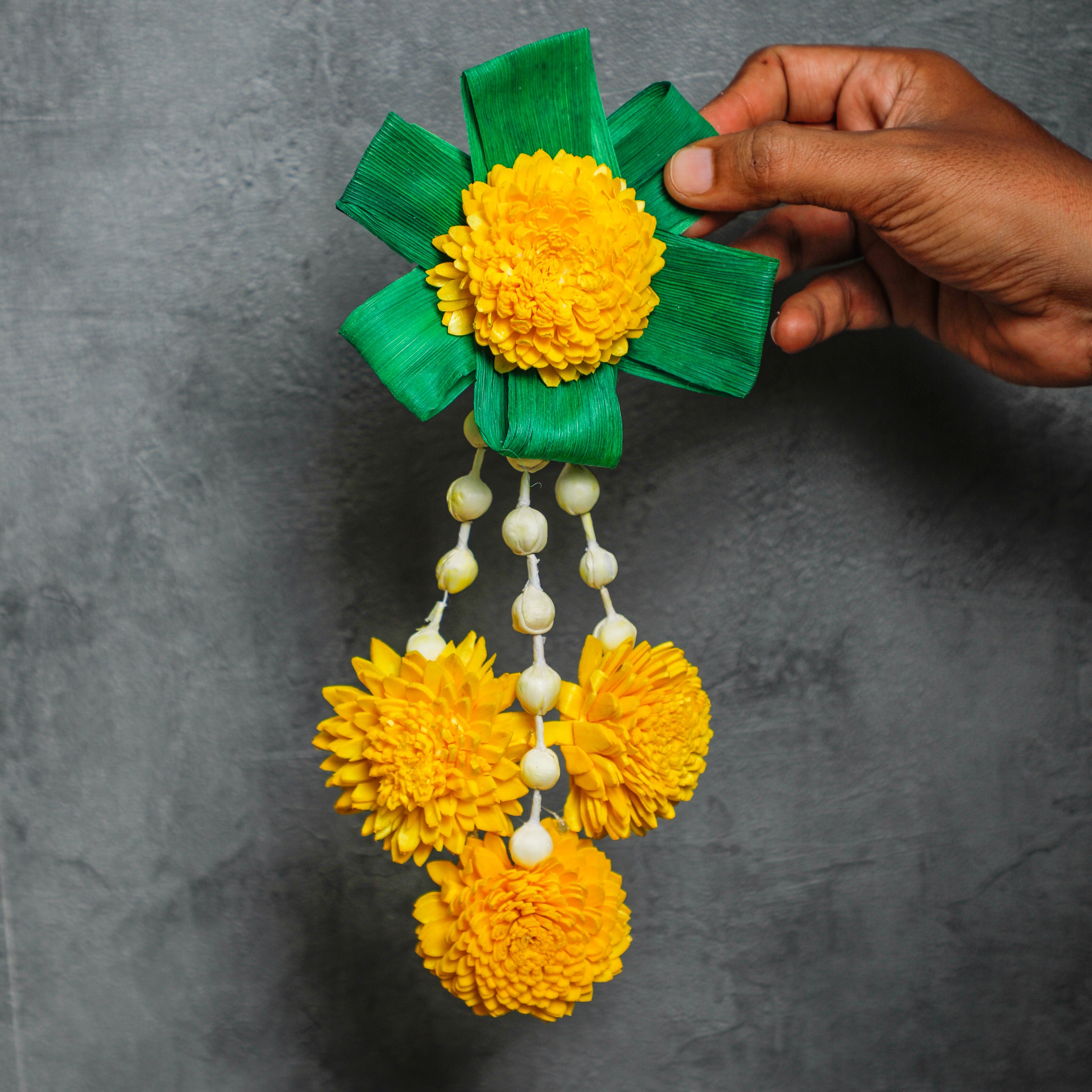 made up of sholapit flowers and palm leaves