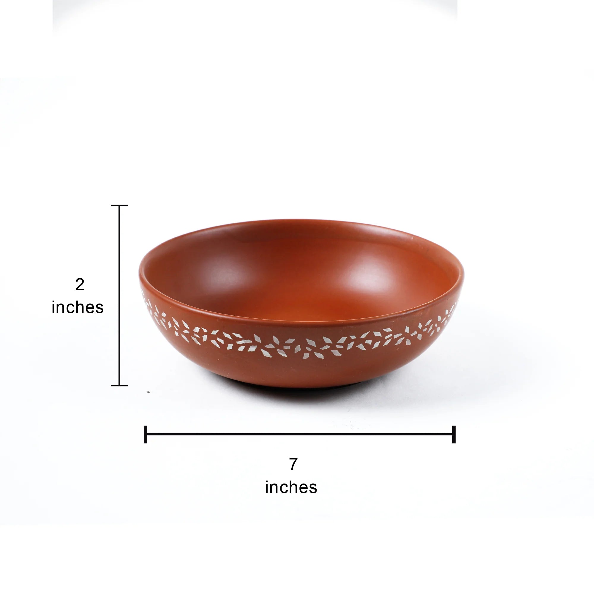 A terracotta-colored ceramic bowl with a decorative leaf pattern around the rim, shown with dimension lines indicating a height of 2 inches and a diameter of 7 inches on a white background.