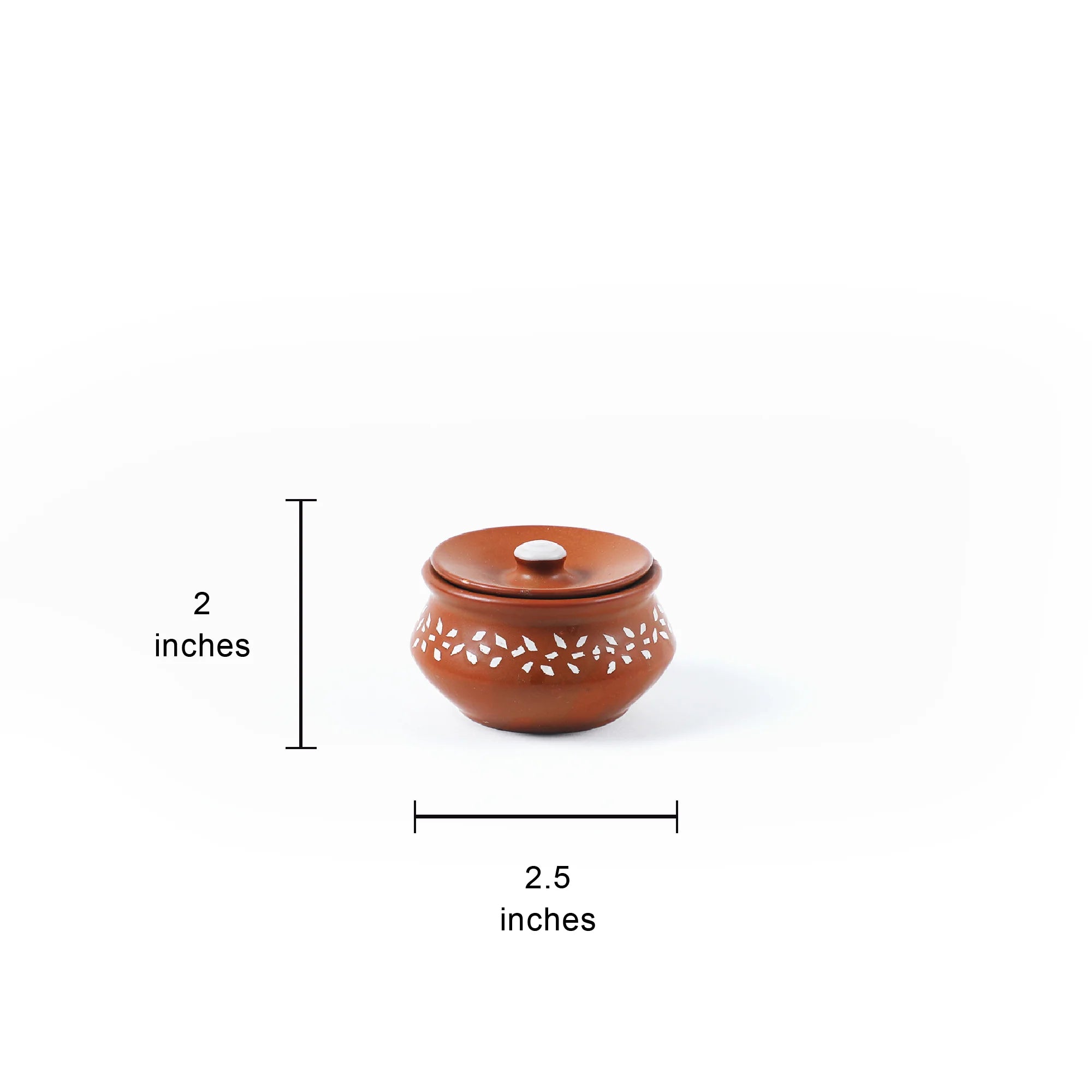A small round brown ceramic lidded container with white leaf cutouts on the body, shown on a white background with dimension lines indicating 2 inches in height and 2.5 inches in width.