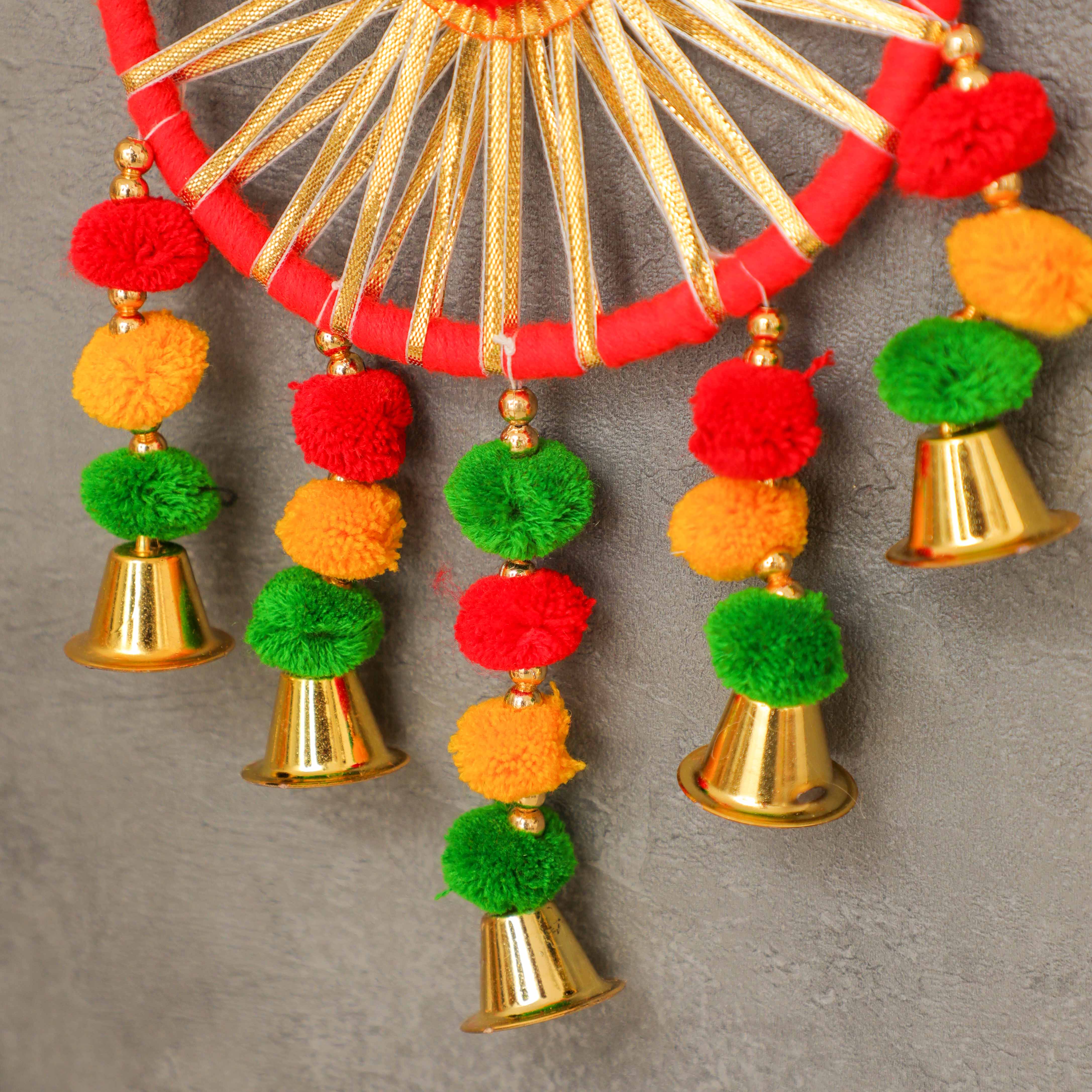 The piece is adorned with pompom with bells and gota work, making it ideal for hanging decor piece