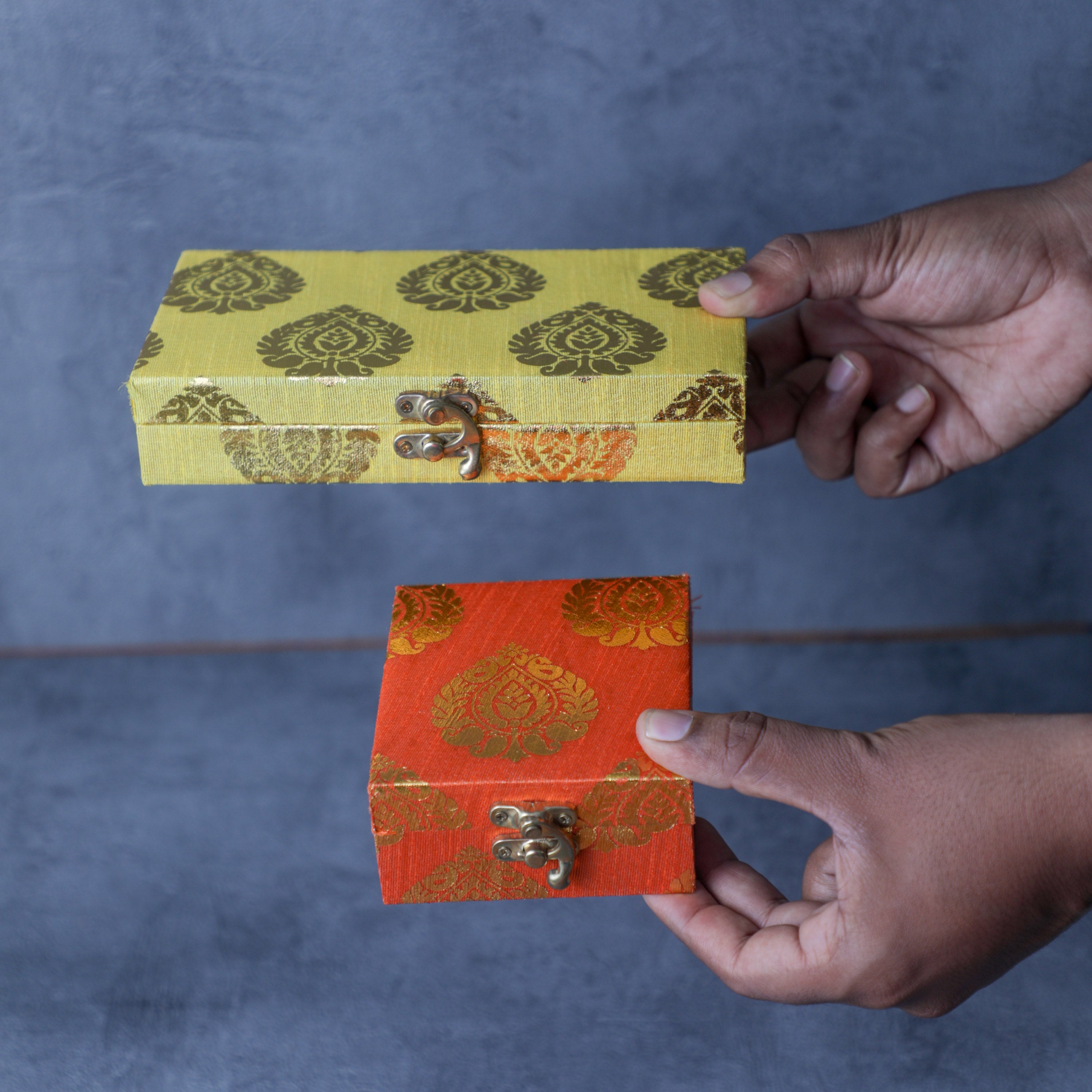 holding favor boxes in hand indian return gifts