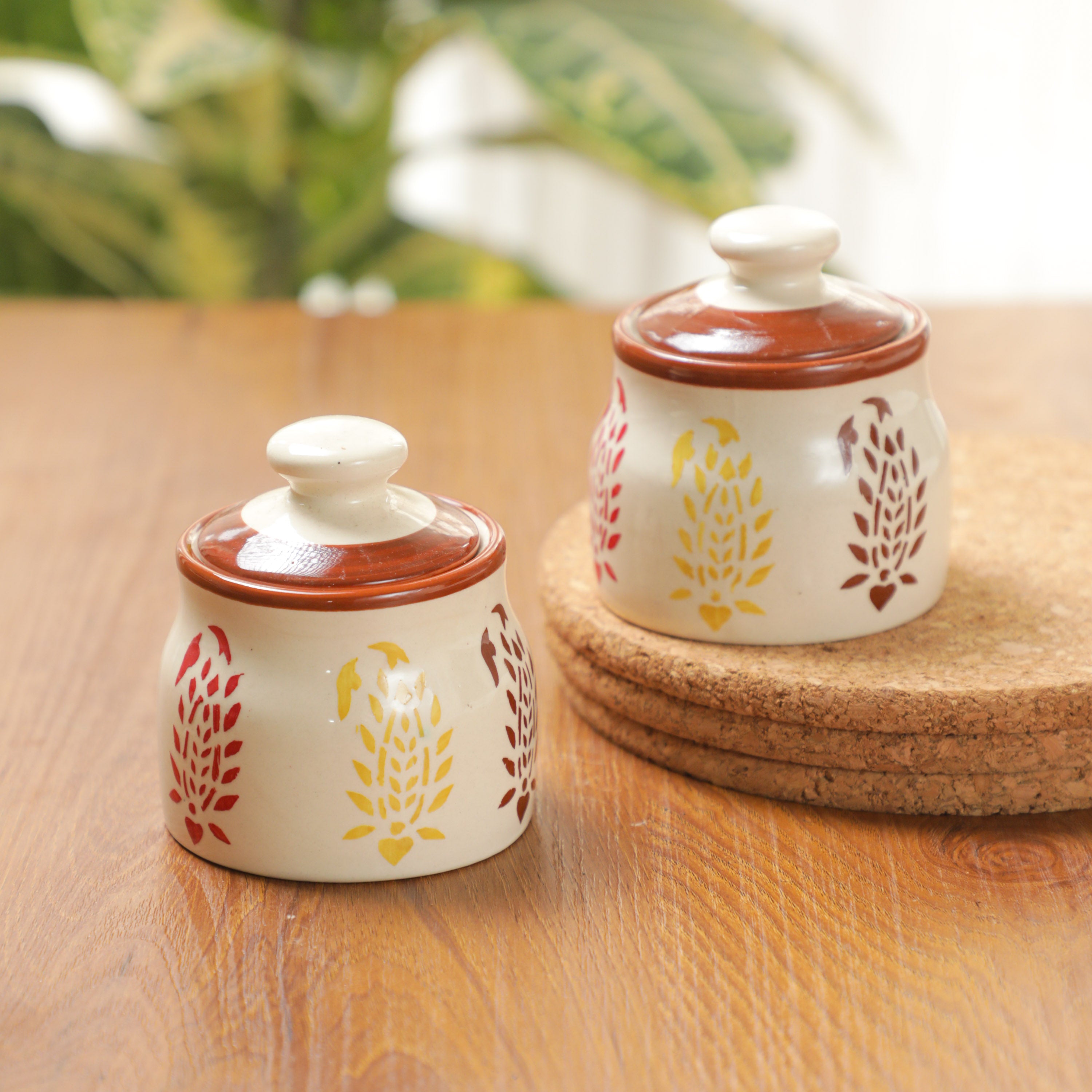 cream and dark brown color jars on the table