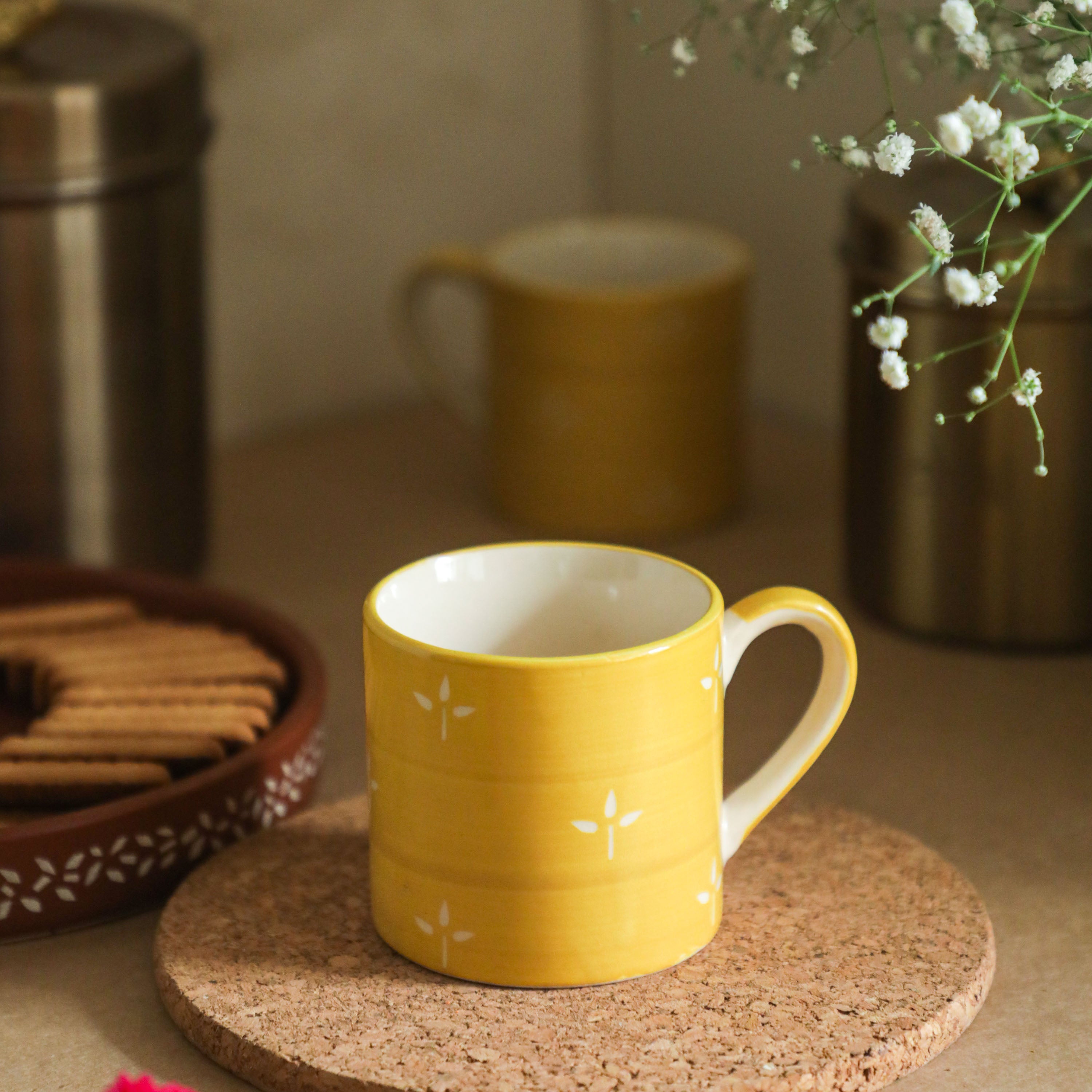 a small petal design on tea cups