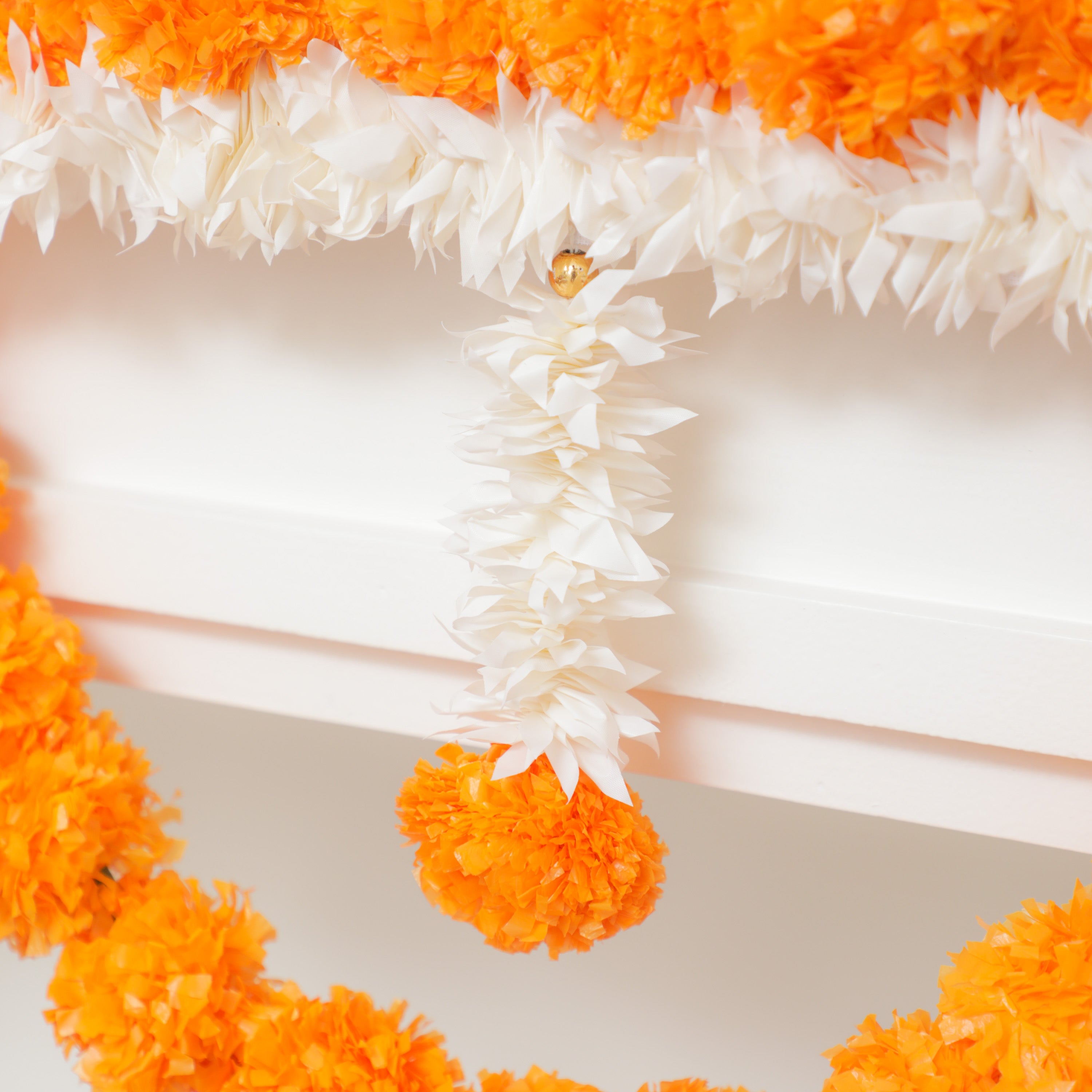 Artificial orange and white entryway torans