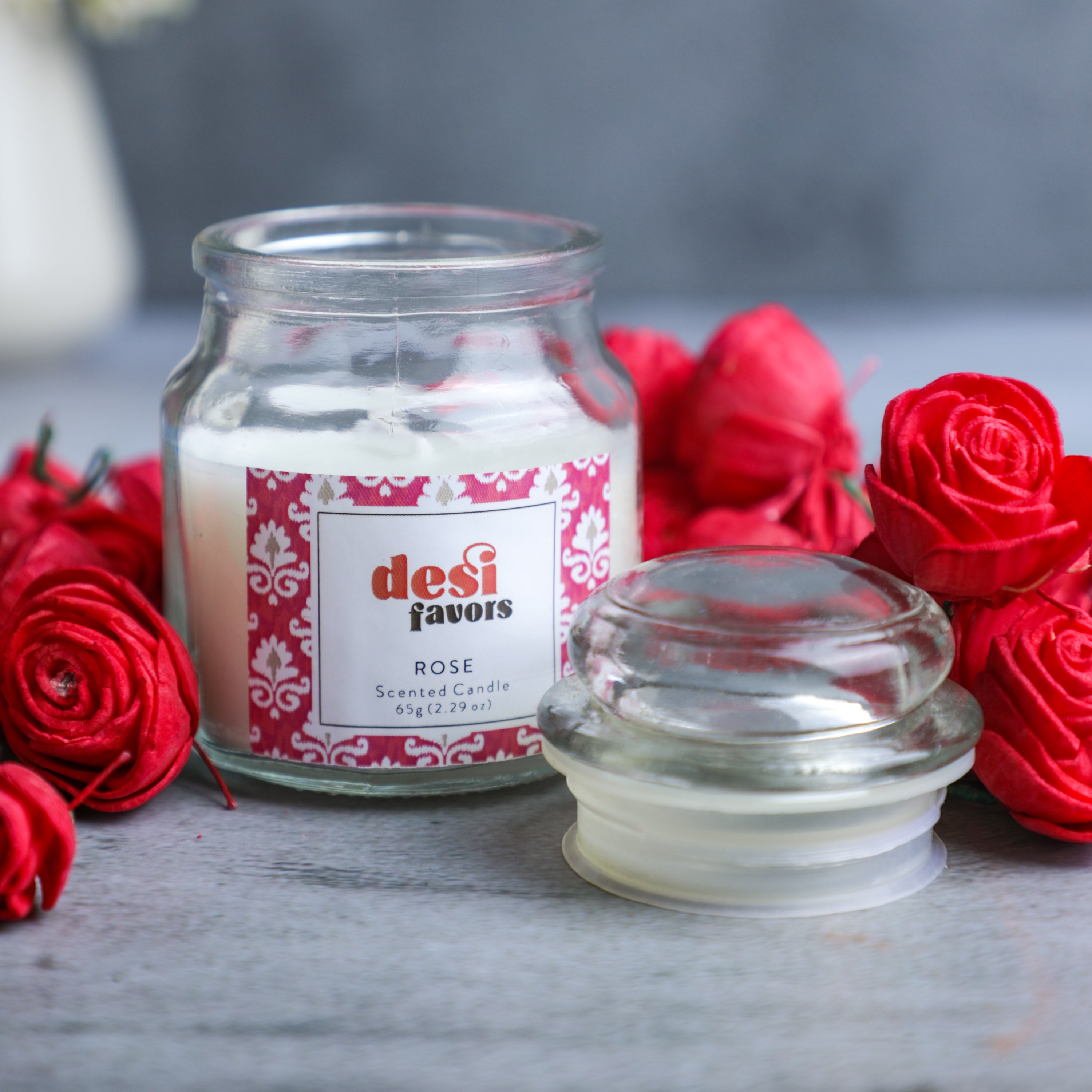 Scented Candle in glass jar with lid, is made with tender, velvety buds and perfectly mixed to a rosy hue.