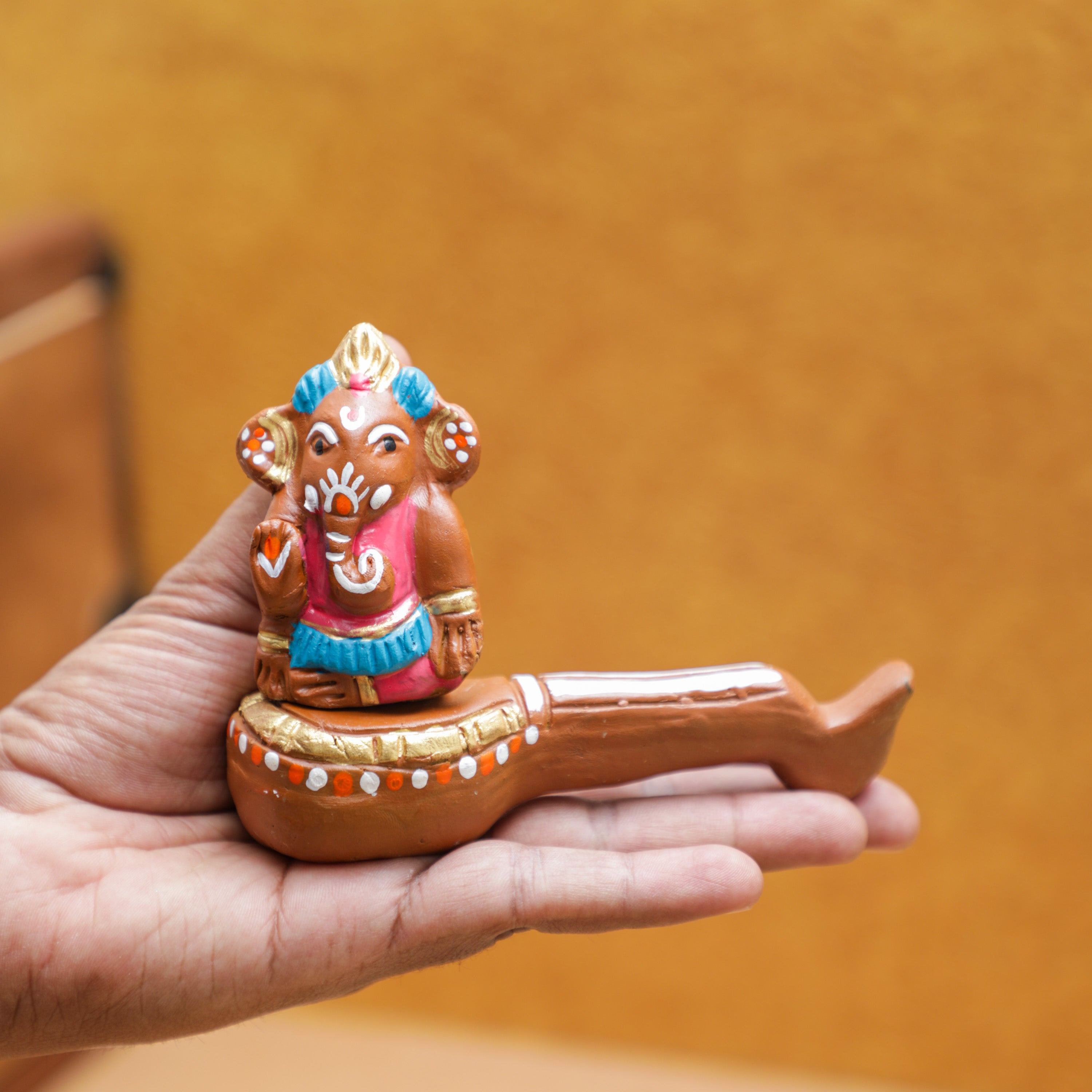 natural clay made ganesha holding in a hand
