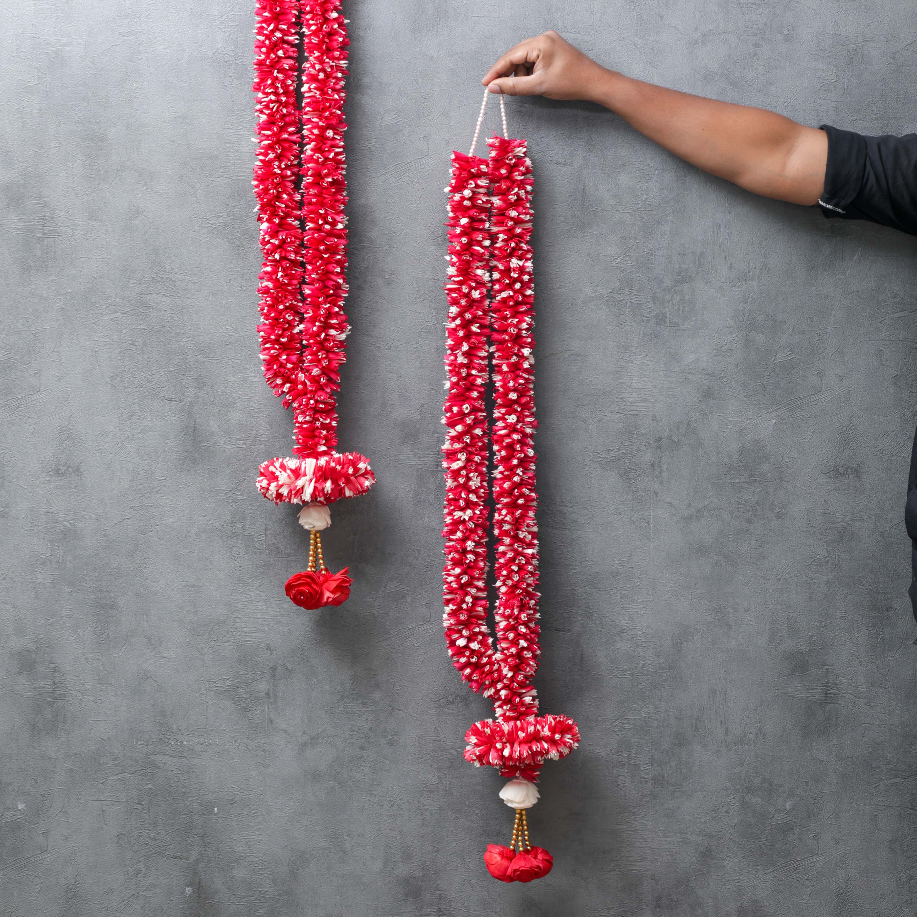 showcasing the size of a wedding garlands in hand