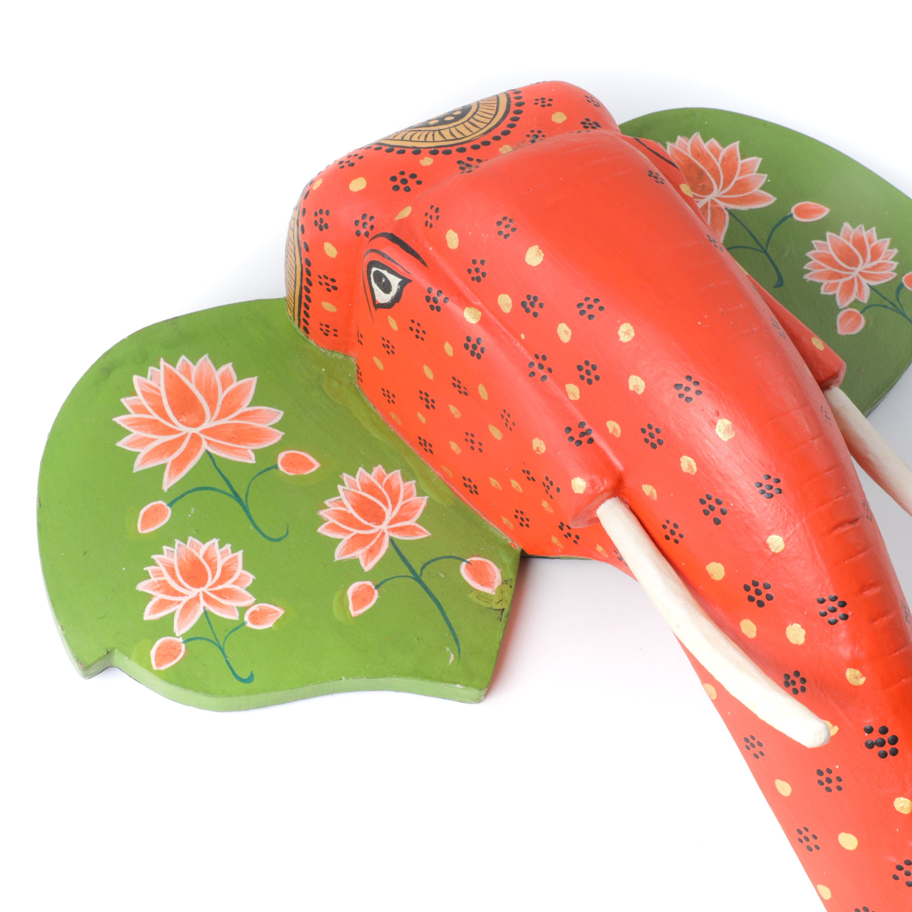 a wooden elephant painted in green and orange color