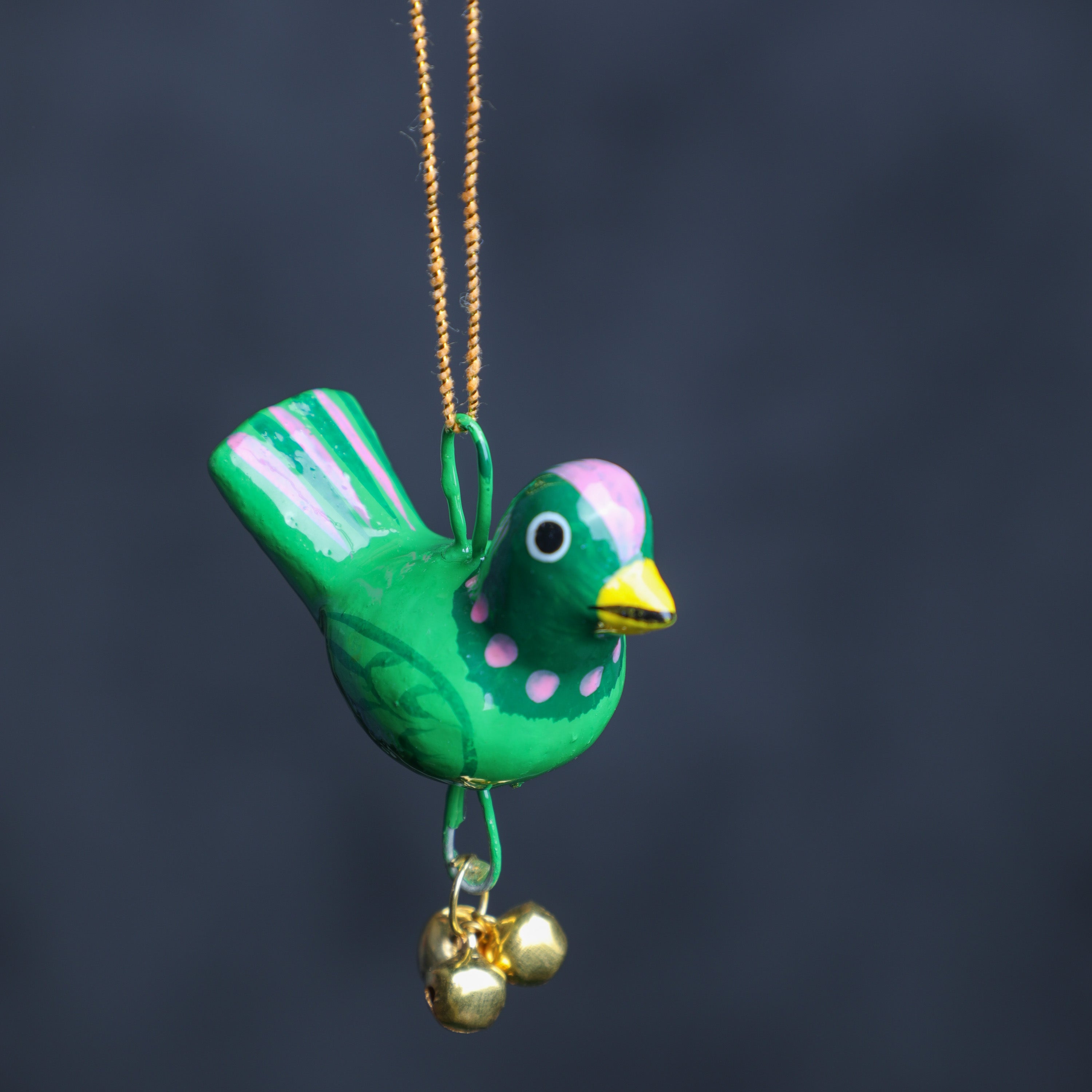 This hand painted hanging parrot chime with bell is crafted in wood
