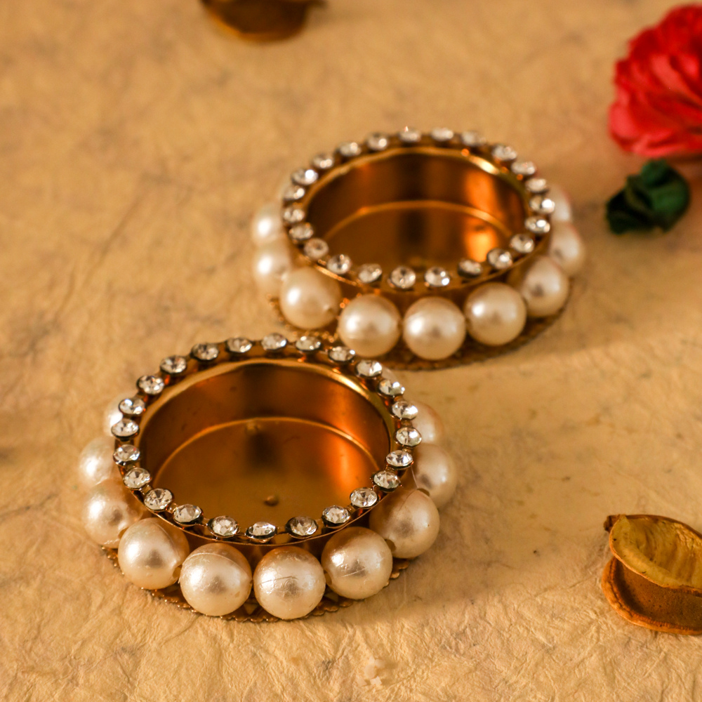 Metal diyas with pearls for diwali festive decorations
