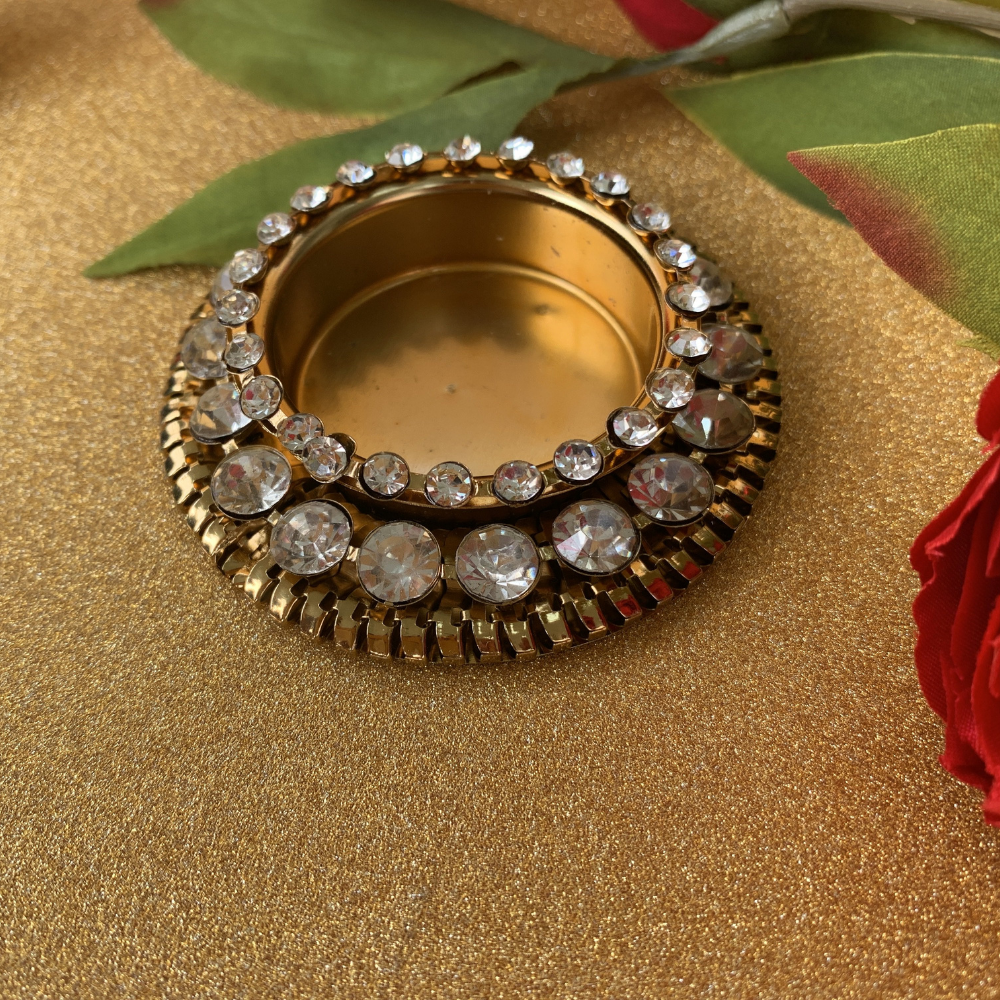 Metal diyas with embedded kundan stones for Diwali decorations